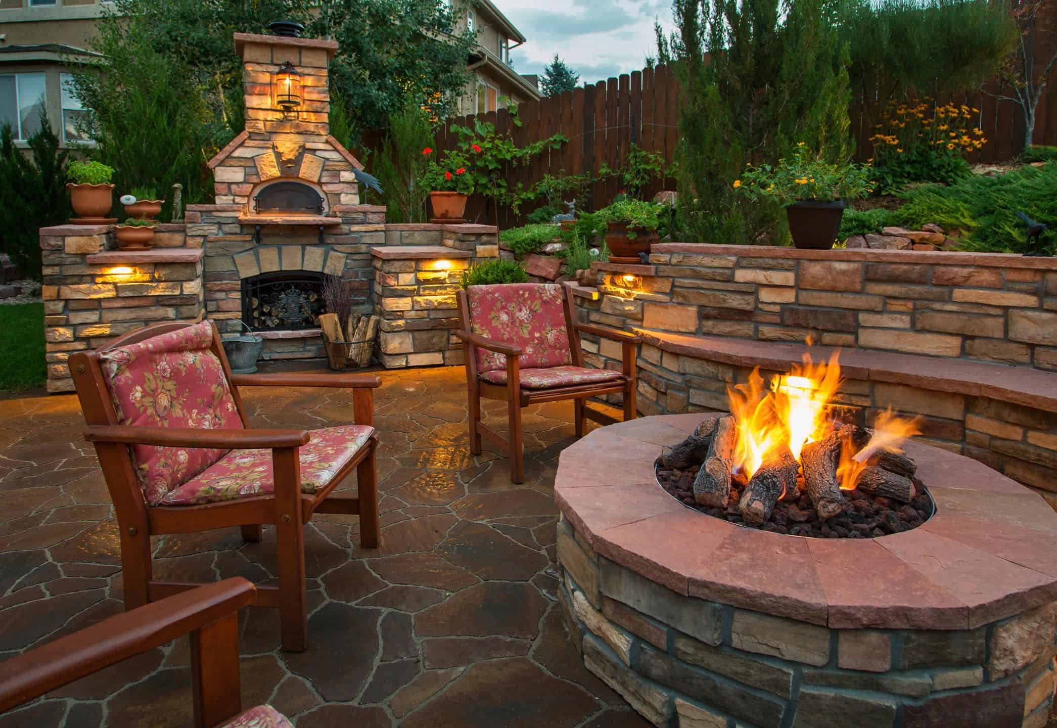 Outdoor entertaining area with fire pit and fireplace in Sandpoint Idaho